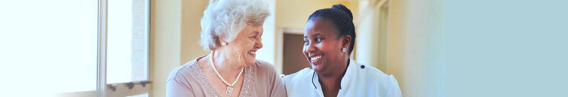 senior woman smiling with caregiver