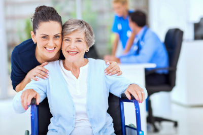 Caring adult daughter accompanying senior mother visiting doctor